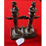 A pair of early 20th century Chinese silver candlesticks, totem column for, on square fenced bases,