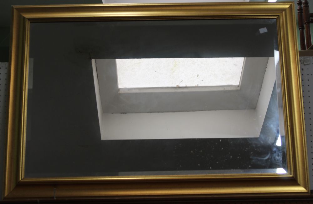 A large gilt framed bevelled edge wall mirror