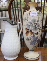 A Parian style lidded ceramic jug marked "JB" with a painted vase