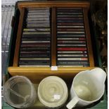 A box containing a wooden CD holder with CD's etc