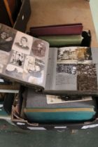 A box containing a selection of photo albums