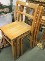 Three vintage stacking wooden school chairs