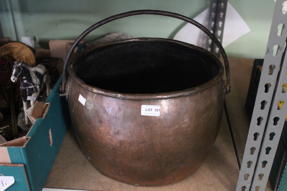 A copper pot with swing iron handle, oval top 32cm x 36cm