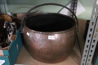 A copper pot with swing iron handle, oval top 32cm x 36cm