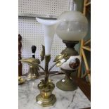A vintage brass and ceramic oil lamp with a brass and glass centre piece
