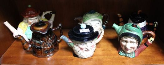 A 19th century Staffordshire pottery "Toby" type splits teapot together with five other figurative a