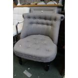 A modern grey upholstered button back easy chair