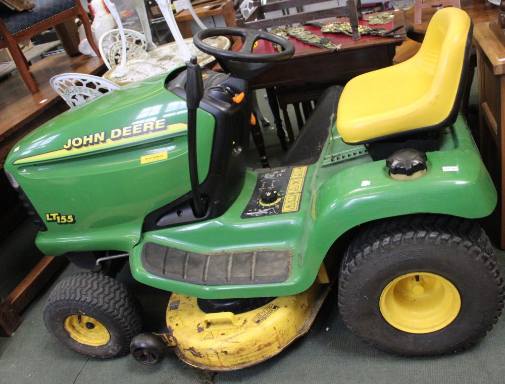 A John Deere LT155 ride-on tractor lawn mower in need of repair