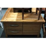 A modern square beechwood coffee table with four drawers