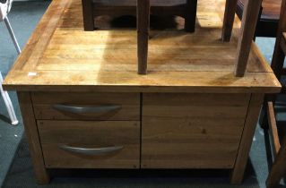 A modern square beechwood coffee table with four drawers