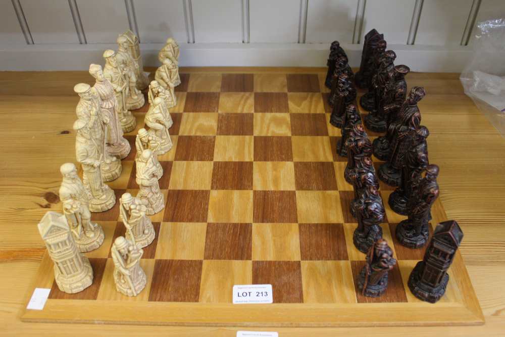 A wooden chessboard together with resin set of chess pieces