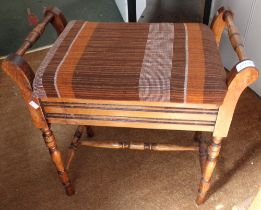 An Edwardian mahogany piano stool with lift up seat