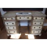 An early 20th century over painted shabby chic knee hole desk