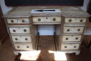 An early 20th century over painted shabby chic knee hole desk