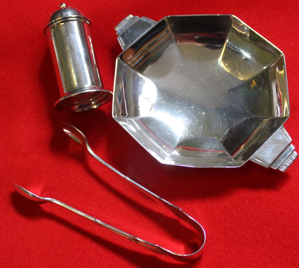 An Art Deco design silver nut dish, together with a silver cylindrical pepper pot and a pair of silv