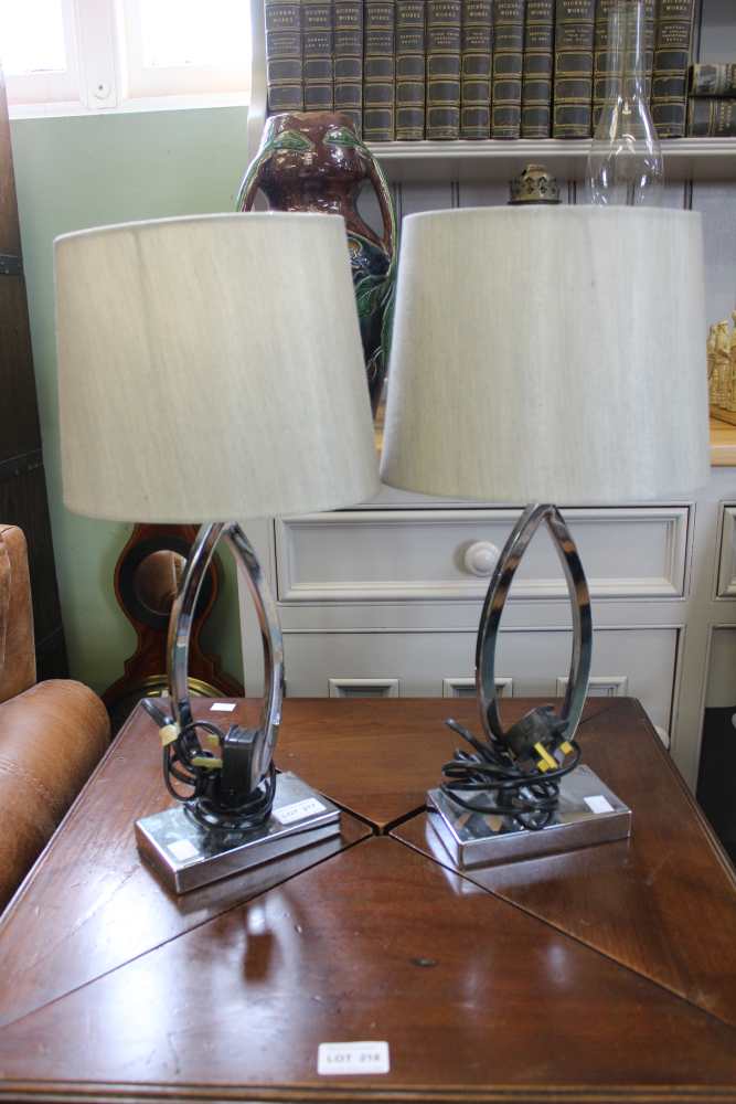 A pair of modern chrome based table lamps