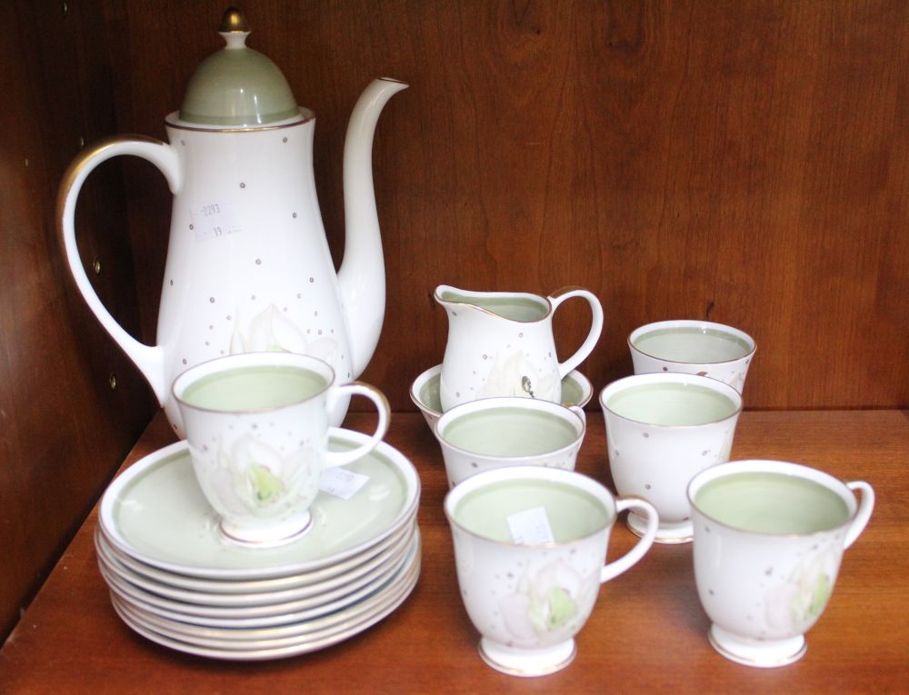 A Susie Cooper coffee service, almond green floral design, gilded, comprising coffee pot, sugar bowl