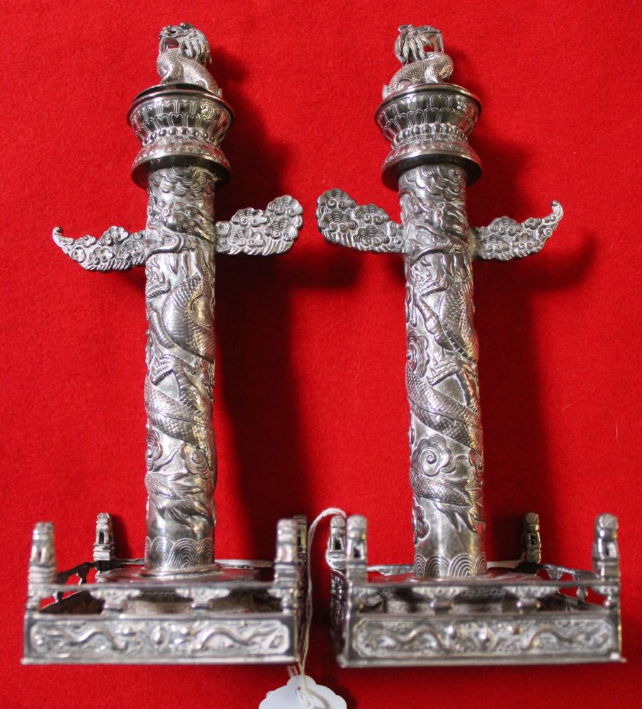 A pair of early 20th century Chinese silver candlesticks, totem column for, on square fenced bases, - Image 2 of 2