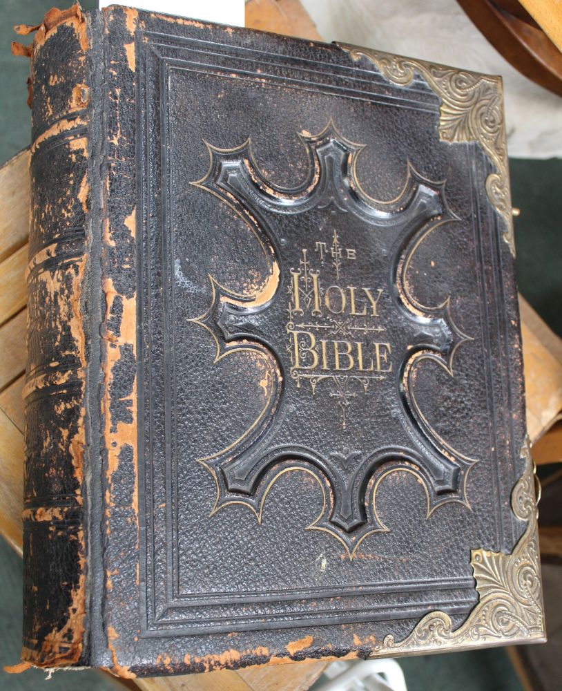 A leather bound Victorian family bible with brass clasps and corners