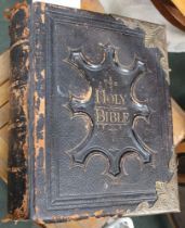 A leather bound Victorian family bible with brass clasps and corners