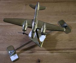 A brass model aircraft, (our vendor remembers that this was a gift to her farming family, in the Sec