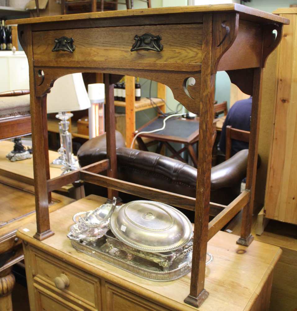 First quarter 20 century side table with tapered legs and original art nouveau style drop handles