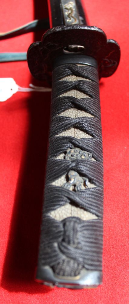 A Japanese sword with shagreen handle cord wrapped. Cast Tsuba. the lacquer scabbard inset small - Image 2 of 3