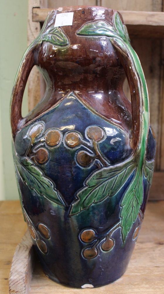 A glazed pottery vase in the manner of Christopher Dresser, having three sprig handles, incised frui - Image 2 of 2