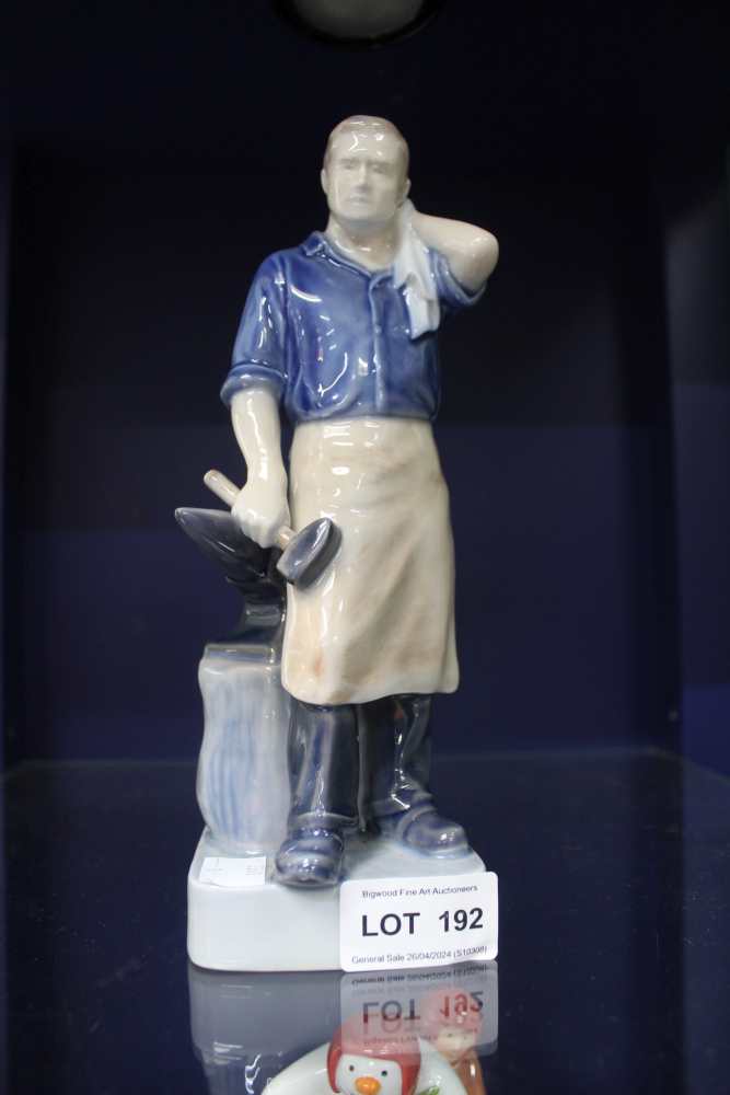 A "Royal Copenhagen" ceramic Blacksmith figure, factory marks include painted number 4502, 22cm high
