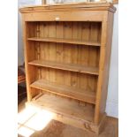 A rustic pine bookcase with four shelves