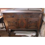 An Old Charm style sideboard with 2 drawers over 2 cupboard doors with carved front