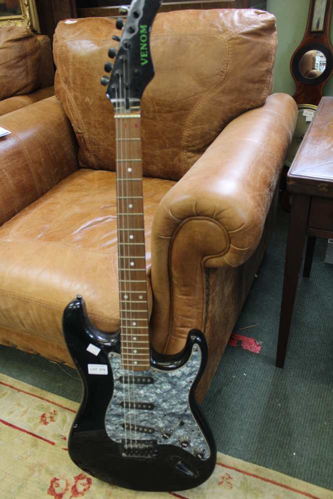 A black Venom electric guitar