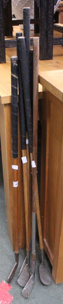 A selection of vintage golf clubs with hickory shaft