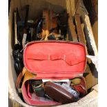 A box containing a selection of vintage items including a camera, wooden plane, cutlery etc