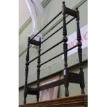 A Victorian mahogany towel rail with unusual turned tapering supports