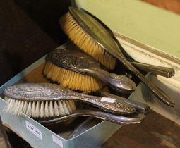 A collection of silver backed dressing table hand brushes and hand mirrors