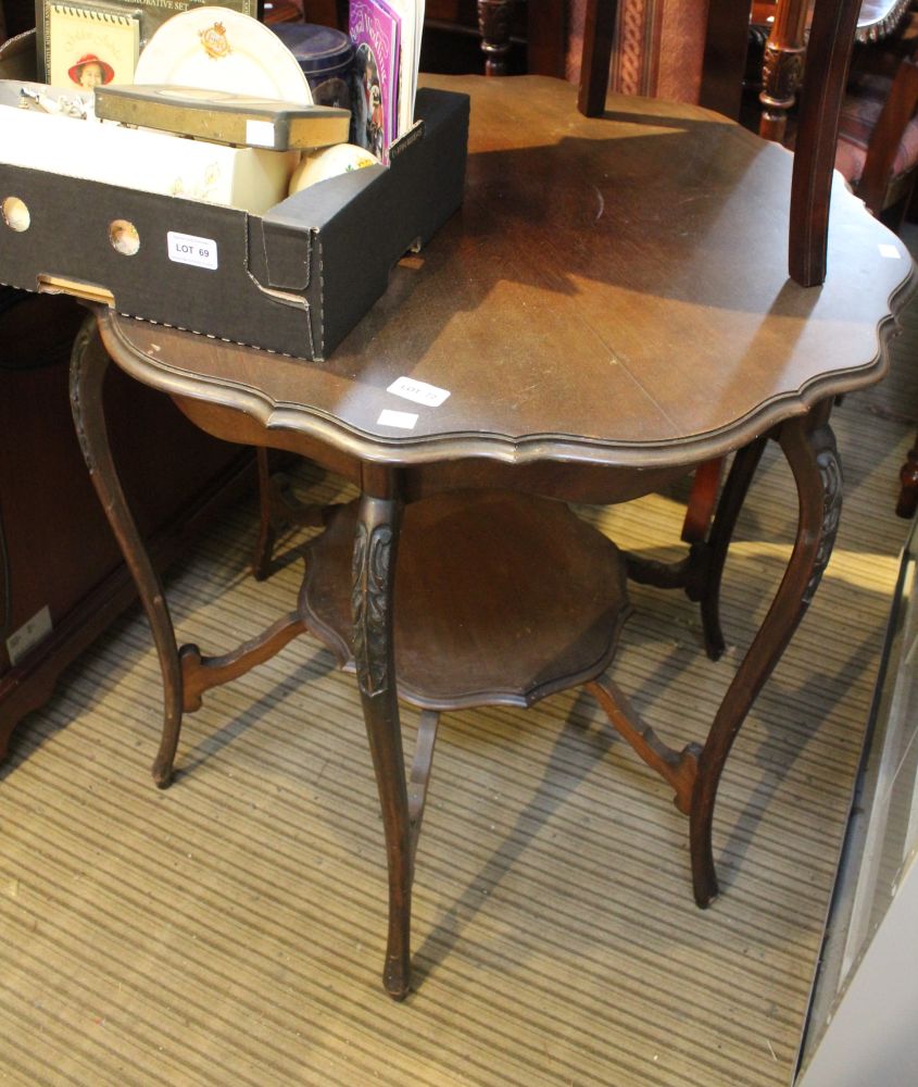 An Edwardian occasional table with scalloped edge and similar under tier
