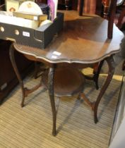 An Edwardian occasional table with scalloped edge and similar under tier