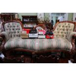 A double spoon back serpentine fronted reproduction hardwood upholstered sofa