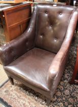 A first quarter 20th century leather armchair with button back
