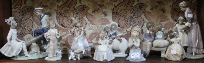 A shelf containing a selection of Lladro and Nao porcelain figurines (9)