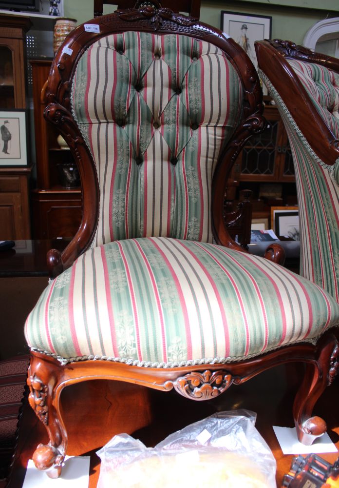 A modern hardwood spoon back upholstered armchair