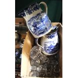 A pair of 19th century blue and white transfer printed ceramic jugs, decorated with Tiger Hunt desig