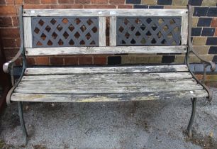 A metal framed wooden slatted garden bench in need of tlc