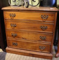 A small satinwood chest of four drawers