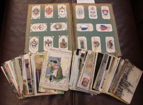 A cigarette card album together with a quantity of early 20th century postcards