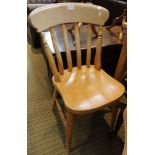 A set of four beech slat back kitchen chairs