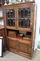 An Old Charm style cabinet with glazed top