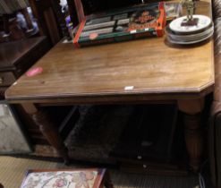 A 19th century wind out dining table on turned legs and casters two additional leaves
