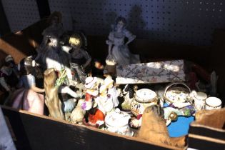 A box containing a wide selection of ceramic figurines including two Beswick Beatrix Potters
